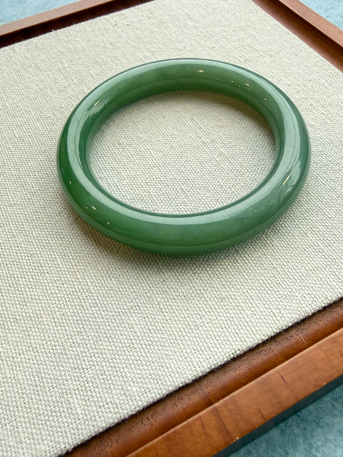 Green jadeite bangle, close-up on tray