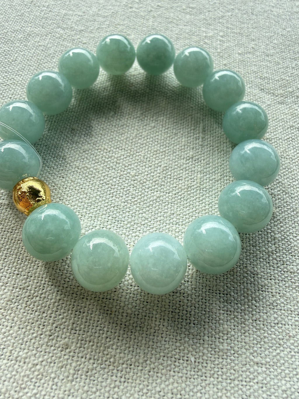 Light green jadeite bead bracelet, close-up of beads — CongCong Jade